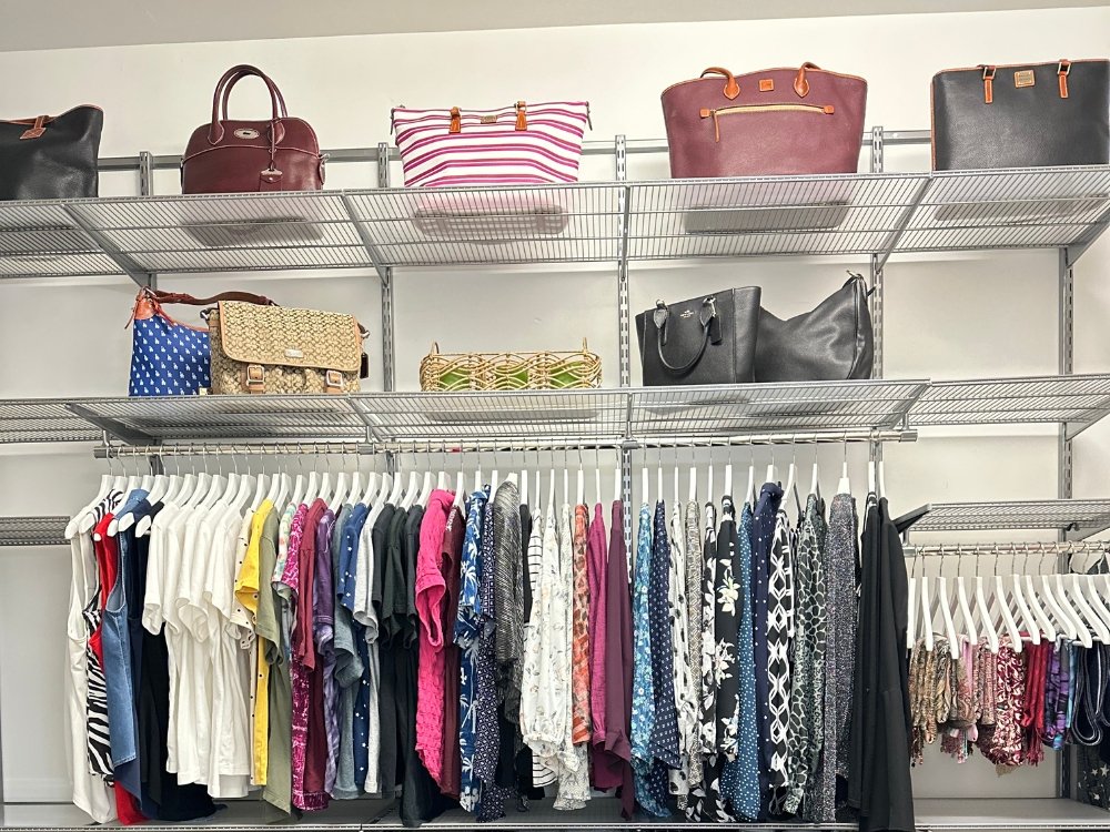 Melinda's custom designed closet filled with a lot of clothes and purses.