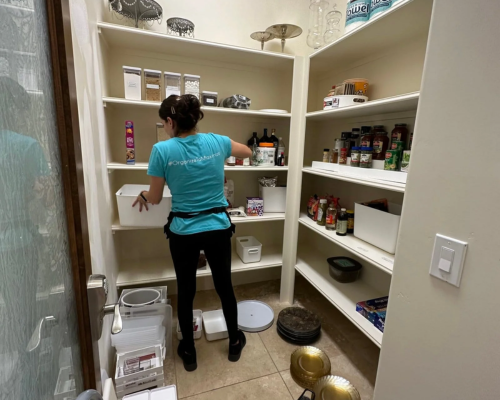 Sarah working to organize a client's pantry