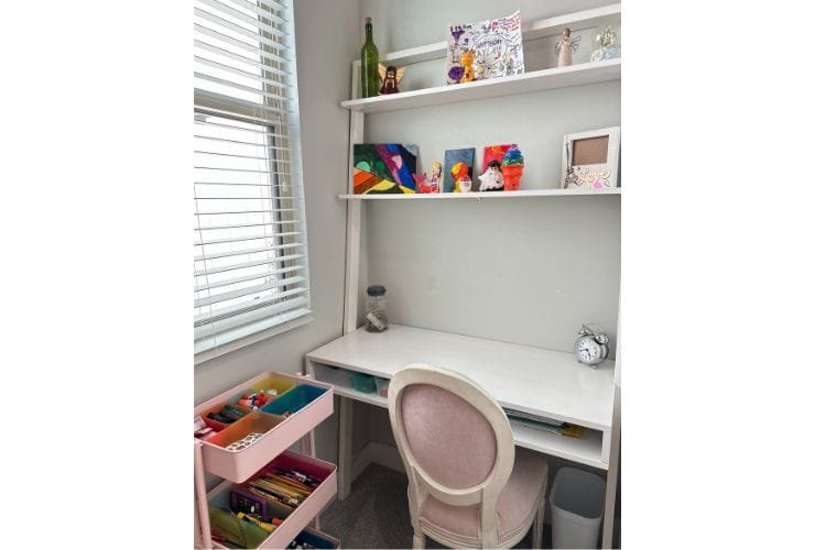 A small room with a desk, chair and bookshelf, perfect for a professional organizer.