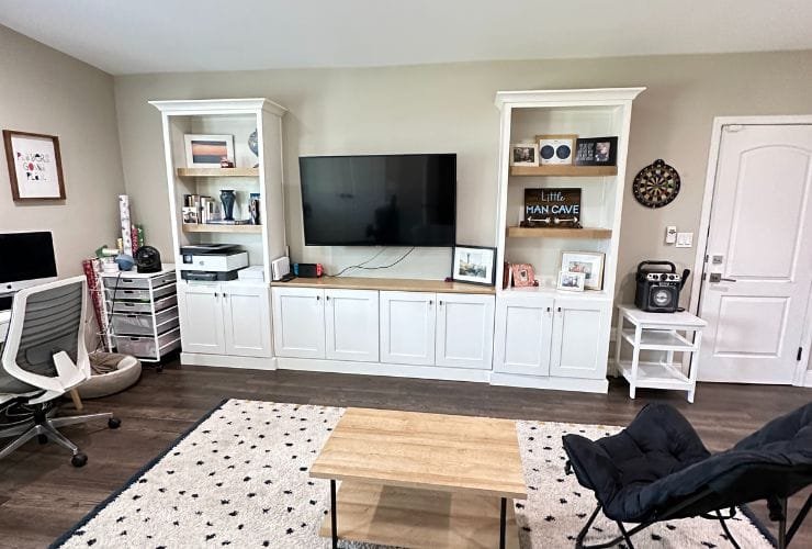 A living room with a tv and a professional organizer's desk.