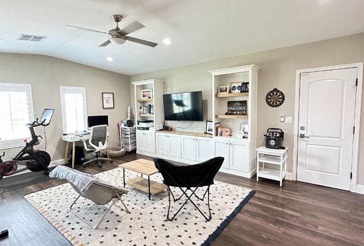 A cozy living room with a TV and a fan, perfect for relaxation or entertainment.