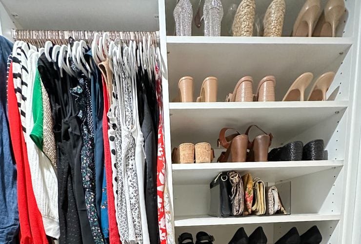 A professional organizer's dream - a meticulously organized closet filled with an extensive collection of shoes and clothes.