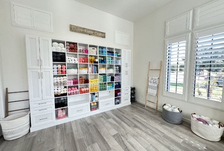 A professional organizer transformed this room into a haven of organization, featuring numerous white shelves and a pristine wooden floor.