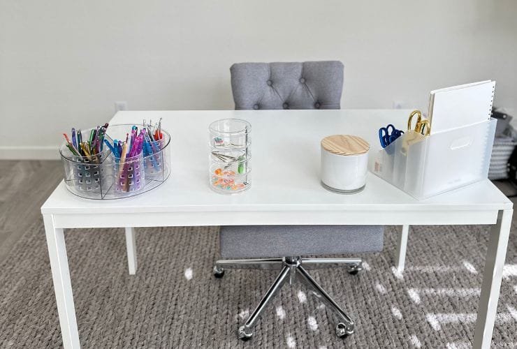 A white desk with professional organizer tools.