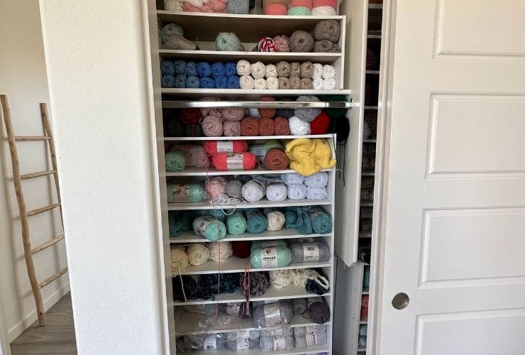 A professional organizer transformed a closet into a yarn haven, stocked with an extensive supply.