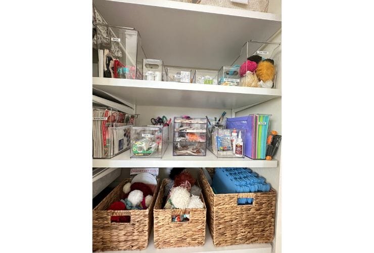 A professionally organized closet filled with an abundant assortment of craft supplies and baskets.
