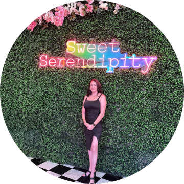 A woman standing in front of a sign that says sweet serendipity, representing a heartwarming moment at home.