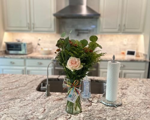 A vase of flowers on a kitchen counter, creating a journey of color and fragrance in the space.