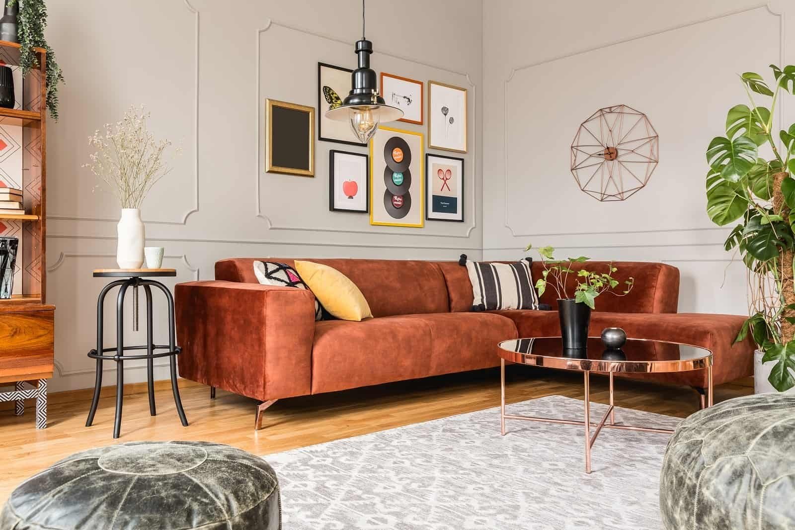 A living room with a brown couch and a coffee table, neatly organized by a professional organizer.